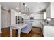 Bright kitchen with white cabinets, granite countertops, stainless appliances, and center island with pendant lighting at 3815 Pleasant Woods Dr, Cumming, GA 30028