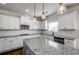 Well-lit kitchen featuring white cabinets, granite countertops, stainless steel appliances, and subway tile backsplash at 3815 Pleasant Woods Dr, Cumming, GA 30028