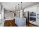 Spacious kitchen showcasing a center island, stainless steel appliances, and opening to living area at 3815 Pleasant Woods Dr, Cumming, GA 30028