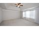 Bright, airy main bedroom with vaulted ceiling, ceiling fan, and large windows dressed with sheer curtains at 3815 Pleasant Woods Dr, Cumming, GA 30028