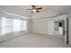 Spacious main bedroom with vaulted ceiling, fan, and natural light, leading to ensuite bathroom at 3815 Pleasant Woods Dr, Cumming, GA 30028