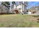 Exterior backyard view of home with stairs leading up to back deck at 4751 Lorient Ct, Snellville, GA 30039