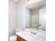 Bathroom with a clean aesthetic featuring a single sink vanity and a large mirror reflecting the shower at 4751 Lorient Ct, Snellville, GA 30039