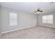 Spacious, carpeted main bedroom featuring a ceiling fan, recessed lighting, and windows with white blinds at 4751 Lorient Ct, Snellville, GA 30039