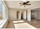 Comfortable living room boasts a ceiling fan, hardwood floors and large windows for ample natural light at 4751 Lorient Ct, Snellville, GA 30039
