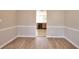 Open floor plan with views into kitchen, wood flooring and neutral color palette at 4751 Lorient Ct, Snellville, GA 30039