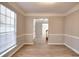 Sun-filled living room with wood flooring, neutral walls, white trim and bright lighting at 4751 Lorient Ct, Snellville, GA 30039