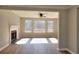 Bright living room features a fireplace, ceiling fan, and large windows with natural light at 4751 Lorient Ct, Snellville, GA 30039