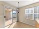 Bright breakfast nook featuring a sliding glass door to the patio, large window, tile floor, and modern lighting at 5790 Mountain Top Pl, Cumming, GA 30041