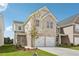 Exterior image of a new construction home featuring a two-car garage, green lawn, and landscaping at 2016 Wyndham Pl, Conyers, GA 30013
