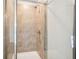 Close up of tile shower with glass door and shower head at 2016 Wyndham Pl, Conyers, GA 30013