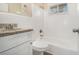 Bathroom with granite countertop, white cabinets, and a shower-tub combo at 2254 Whites Mill Rd, Decatur, GA 30032