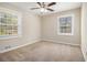 Neutral bedroom with two windows, standard ceiling fan, and neutral carpet at 2254 Whites Mill Rd, Decatur, GA 30032