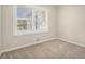 A small carpeted bedroom with a large window offering bright natural light at 2254 Whites Mill Rd, Decatur, GA 30032