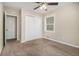 A carpeted bedroom featuring a window, closet, and neutral walls at 2254 Whites Mill Rd, Decatur, GA 30032