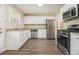 Modern kitchen featuring stainless steel appliances, granite countertops, and white cabinets at 2254 Whites Mill Rd, Decatur, GA 30032