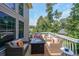 Back deck area with comfortable seating and a table firepit overlooking a lush backyard at 4408 Meadowwood Dr, Loganville, GA 30052