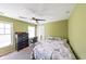 Bedroom features neutral carpet, green walls, ceiling fan, and a desk at 4408 Meadowwood Dr, Loganville, GA 30052