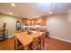 Dining room features wood floors and a view into the kitchen at 4408 Meadowwood Dr, Loganville, GA 30052