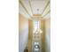 Foyer boasts tray ceiling and a chandelier above the front door at 4408 Meadowwood Dr, Loganville, GA 30052