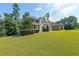 Spacious front yard showcasing a well-maintained lawn and mature trees surrounding the home at 4408 Meadowwood Dr, Loganville, GA 30052