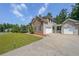 Attached two-car garage with extended driveway, providing ample parking and storage space at 4408 Meadowwood Dr, Loganville, GA 30052