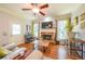 Cozy living room featuring a stone fireplace, hardwood floors, and natural light at 4408 Meadowwood Dr, Loganville, GA 30052