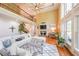 Spacious living room with fireplace, large windows, and stylish white sectional at 4408 Meadowwood Dr, Loganville, GA 30052
