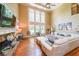 Elegant living room with fireplace, large windows and hardwood floors at 4408 Meadowwood Dr, Loganville, GA 30052