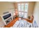 Bright living room with high ceilings, fireplace, and large windows offering ample natural light at 4408 Meadowwood Dr, Loganville, GA 30052