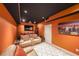 Home theater features recliners, movie projector and screen with orange walls and black ceiling at 4408 Meadowwood Dr, Loganville, GA 30052