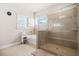 Bright bathroom featuring a glass shower, soaking tub, and neutral tile flooring at 4826 Ralin Ct, Atlanta, GA 30331