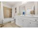 Bright bathroom with a combination tub and shower, white vanity, and neutral tile flooring at 4826 Ralin Ct, Atlanta, GA 30331