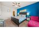 Bedroom featuring a queen bed with a colorful comforter and a bold blue accent wall at 4826 Ralin Ct, Atlanta, GA 30331