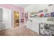 bedroom with pink walls, a dresser, and shelves filled with books and toys at 4826 Ralin Ct, Atlanta, GA 30331