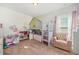 Cozy bedroom featuring a bunk bed with whimsical house-themed decor and a plush armchair at 4826 Ralin Ct, Atlanta, GA 30331
