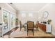 Bright dining area with a round table, upholstered chairs, and a stylish cabinet with a modern lamp at 4826 Ralin Ct, Atlanta, GA 30331