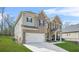 Side view of a two-story brick home with an attached garage and well maintained lawn on a sunny day at 4826 Ralin Ct, Atlanta, GA 30331
