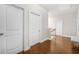 Upstairs hallway featuring hardwood floors, white walls, and access to bedrooms at 4826 Ralin Ct, Atlanta, GA 30331