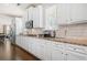 Well-lit kitchen with wooden floors, white cabinetry, granite countertops, and stainless steel appliances at 4826 Ralin Ct, Atlanta, GA 30331