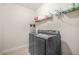Laundry room with modern front-loading washer and dryer and storage shelf at 4826 Ralin Ct, Atlanta, GA 30331
