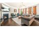 Elegant living room with sofas, armchairs, a fireplace, and large windows with decorative curtains at 4826 Ralin Ct, Atlanta, GA 30331