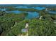 Aerial view of lakefront property with lush trees, the community pool and tennis courts at 1620 Rising Mist Ln, Cumming, GA 30041