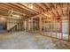 Unfinished basement with concrete flooring and studded walls at 1620 Rising Mist Ln, Cumming, GA 30041