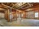 Unfinished basement featuring concrete floor, exposed ceiling and studded walls at 1620 Rising Mist Ln, Cumming, GA 30041