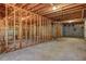 Unfinished basement featuring concrete flooring and exposed framework at 1620 Rising Mist Ln, Cumming, GA 30041