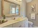 Well-lit bathroom with white vanity, decorative mirror, and neutral wall color at 1620 Rising Mist Ln, Cumming, GA 30041