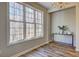 Bright dining area featuring large windows, hardwood floors, and an elegant console table with decor at 1620 Rising Mist Ln, Cumming, GA 30041