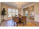 Bright dining room featuring a round table, chandelier, and large windows for natural light at 1620 Rising Mist Ln, Cumming, GA 30041