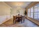 Bright dining room featuring a round table, chandelier, and large windows for natural light at 1620 Rising Mist Ln, Cumming, GA 30041